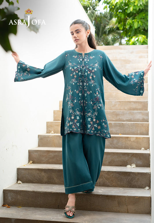 Asra Jofa ASAE-02 teal embroidered cambric 2-piece suit with bell sleeves – model posing with arms extended on stairs
